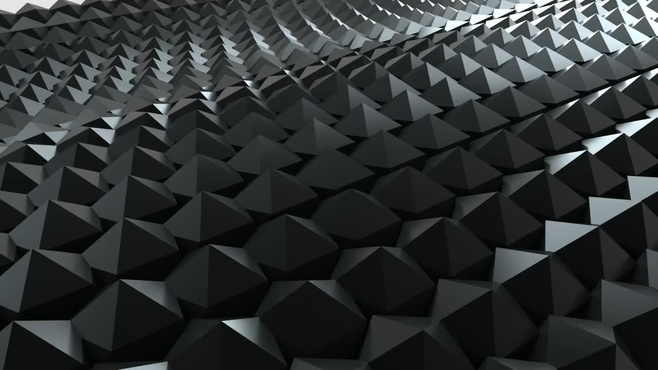 Abstract animation of a field of black pyramids undulating and shifting with subtle light play. Moody, geometric, and futuristic tech background