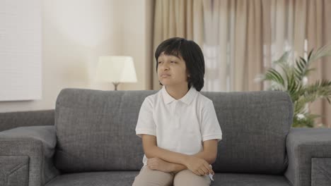 upset indian boy slapping his head