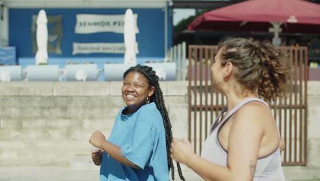 side view of happy fat women talking while running outside