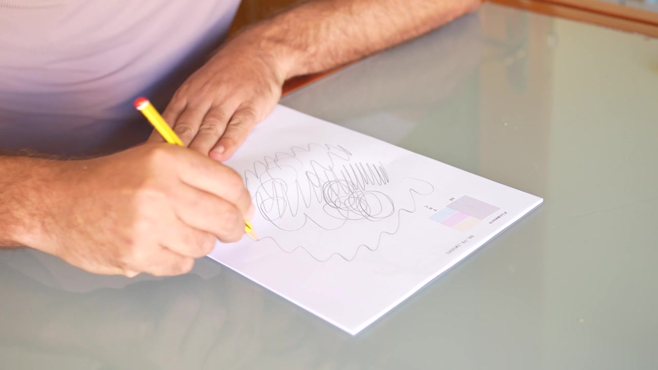 Exploring the creative writing process using a yellow pencil on a clean white paper surface