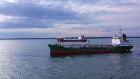 passenger boat and oil tanker ship navigating near port of balikpapan in kalimantan, indonesia