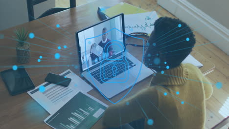 person in virtual meeting with data processing animation over laptop screen