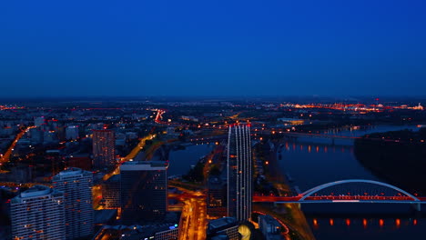 bratislava, slovakia, 2 june 2025: bratislava evening skyline. bratislava at dusk, with illuminated buildings and a winding river against the darkening sky