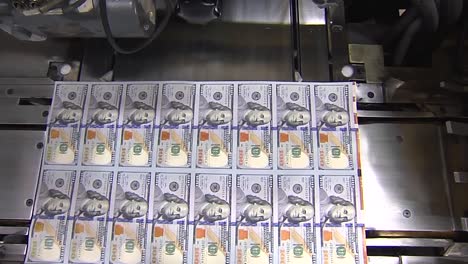 SHEET-OF-100-DOLLAR-BILLS-AT-PRINTING-PRESS-WIDE-SHOT