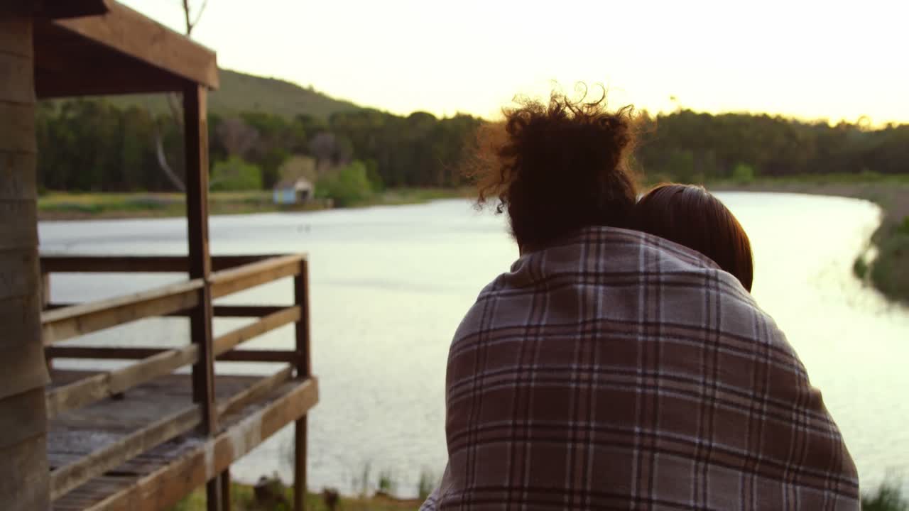 Rear view of couple standing near lakeside 4k