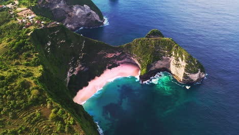 Beach-with-turquoise-sea-lagoon-below-cape-ridge-with-lush-foliage