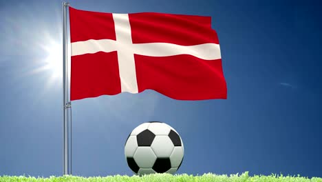 flag of denmark fluttering and a football rolls on the lawn, 3d rendering, 4k footage