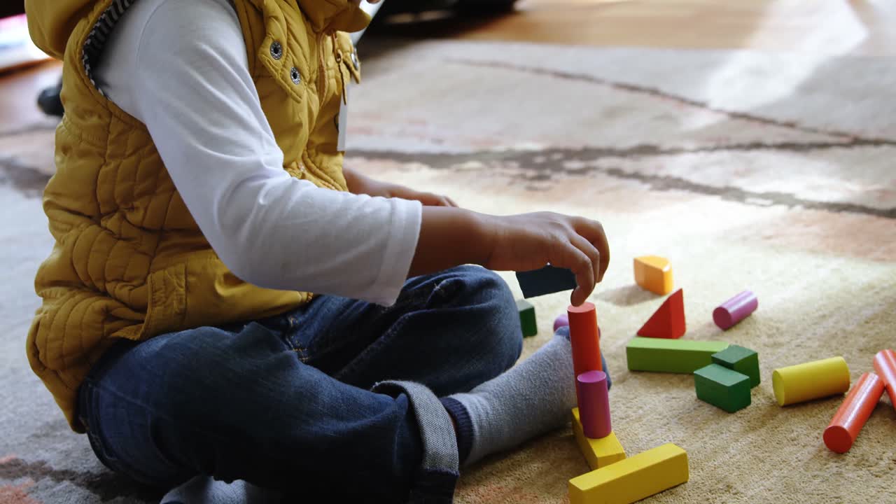 Boy playing with building blocks in a comfortable home 4k