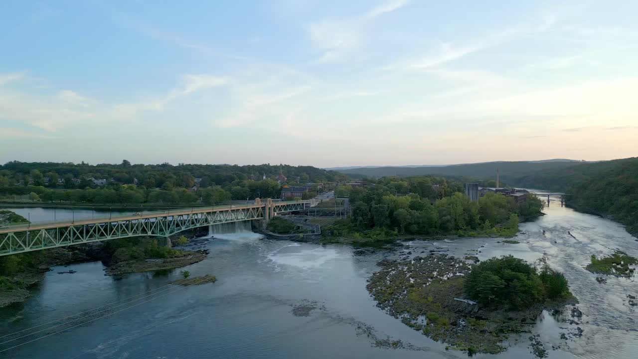 Panoramic drone fly at the iconic Turners Falls-Gill Bridge with flowing Connecticut River, Montague, Massachusetts, USA
