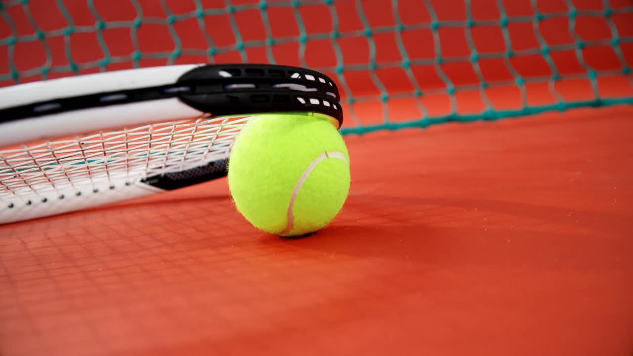 Racket arranged on tennis ball in court 4k