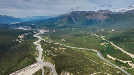 Scenic view on the wilderness of Alaska, USA. Drone footage over the vast valley, river and stunning mountains