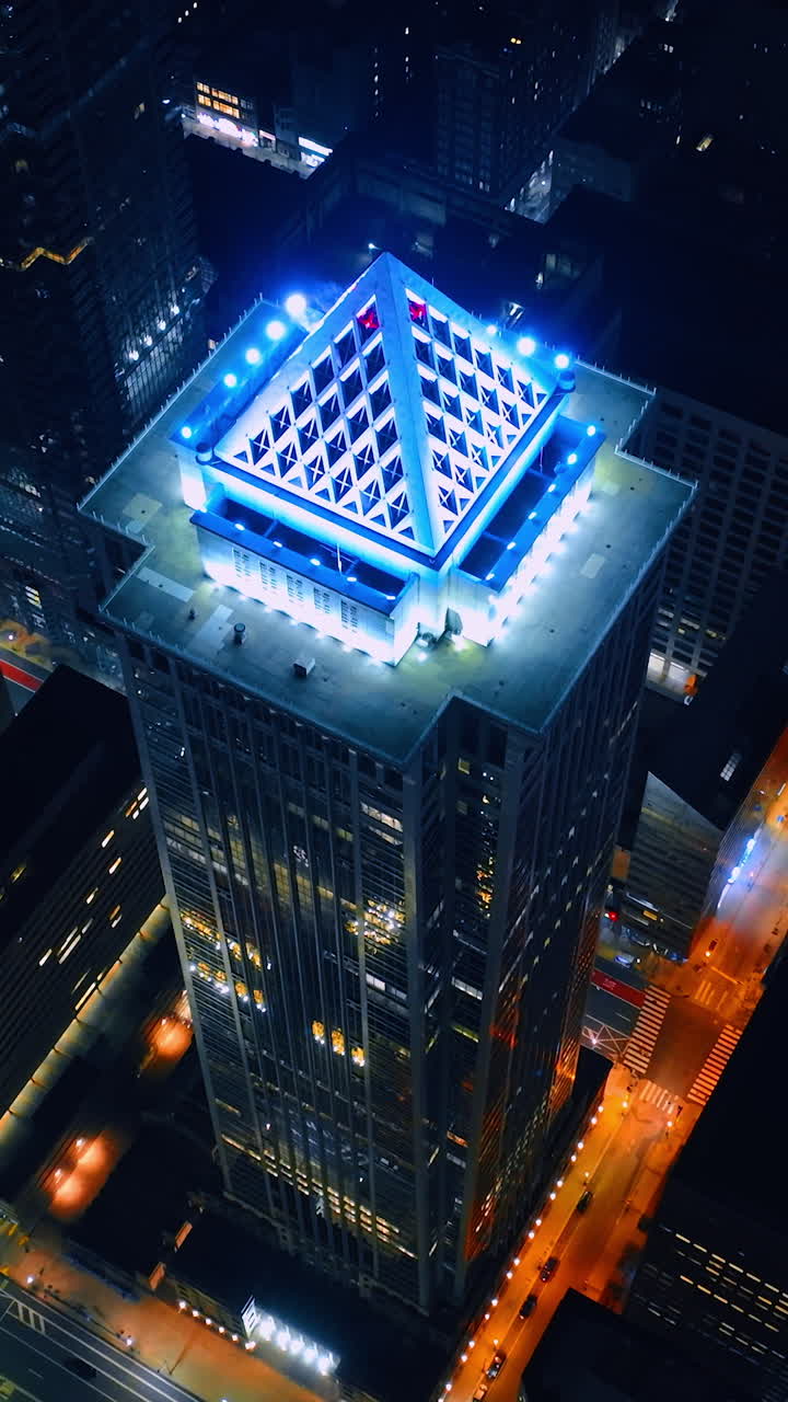 High tower building with the light top. Night city panorama from aerial perspective. Philadelphia, Pennsylvania, USA. Vertical video