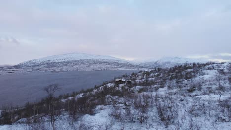 View-from-nordic-lake-to-Scandinavian-Mountain-Range---Aerial-reveal-shot