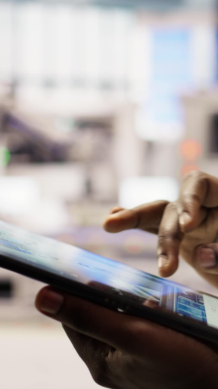 Vertical video Close up of engineer using tablet to design solar panels factory layouts