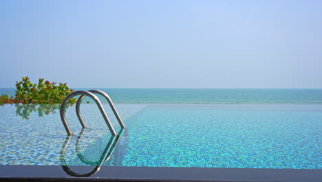 a swimming pool ladder just out of the transparent water