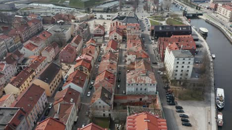 AERIAL:-Klaipeda-Old-Town-with-Old-Historic-Houses-and-Traffic-in-Background