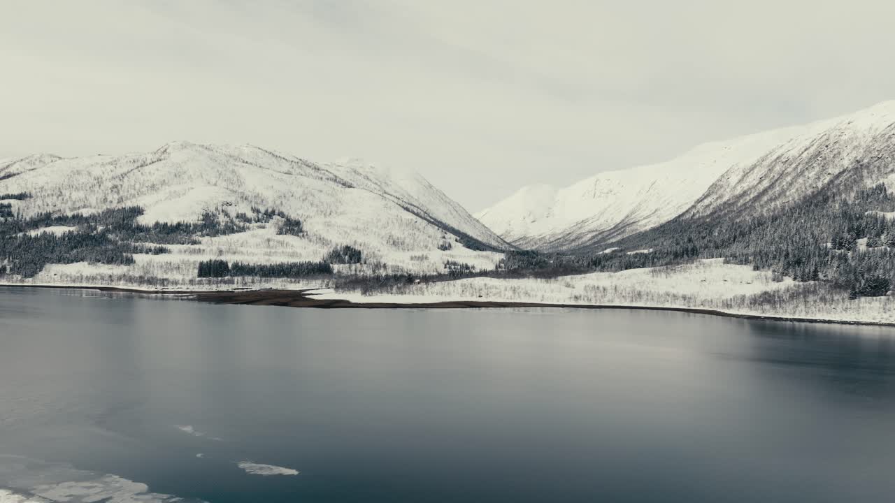 Tranquilness Of Lake And Snow-Covered Mountains Across The Road Near Svolvaer, Nordland, Norway. Aerial Drone Shot