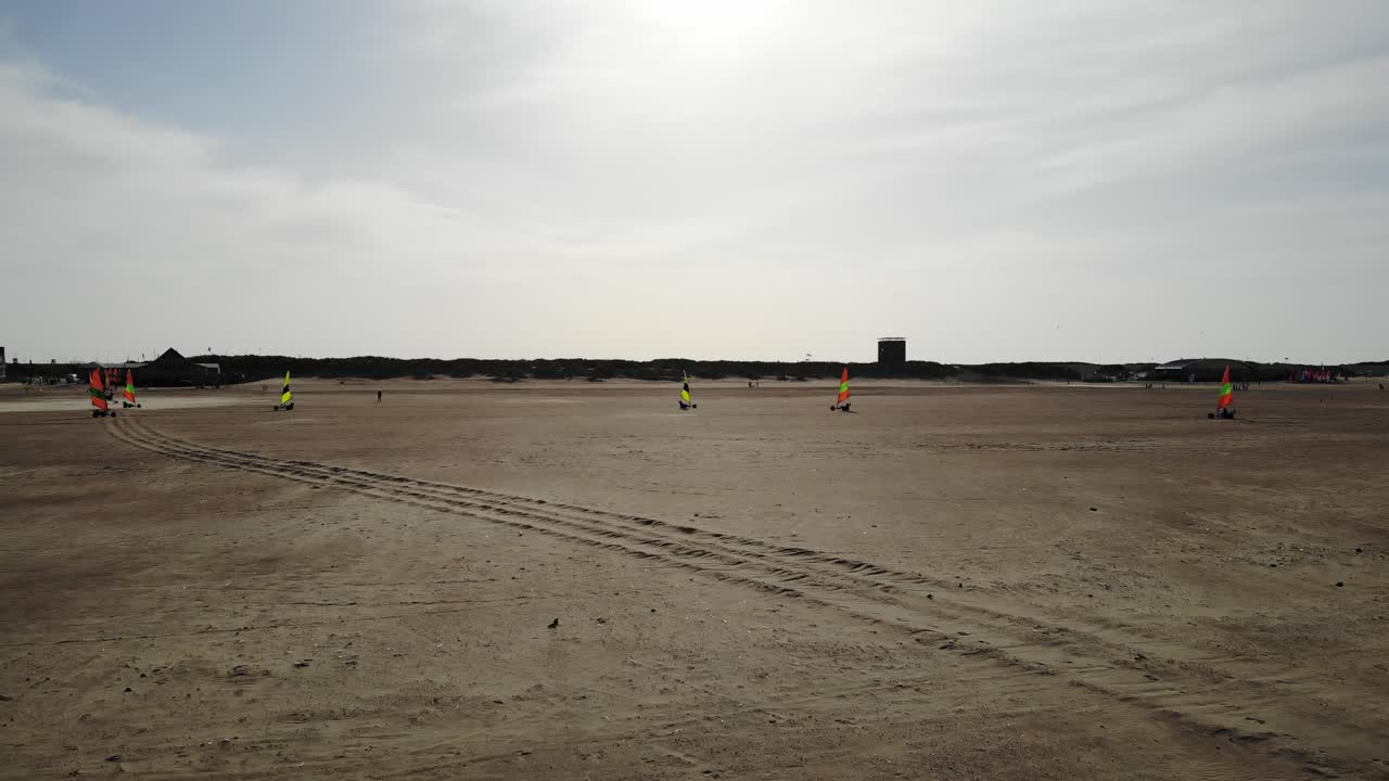 Aerial view of land sailing, land yachting or dirtboating on the beach in summer