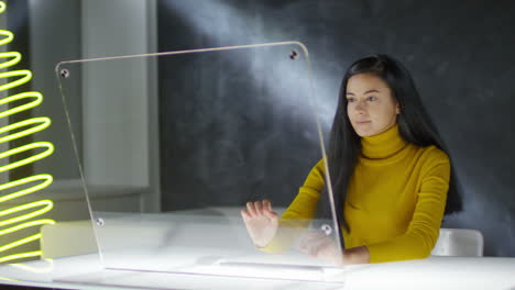 woman interacting with a blank methacrylate screen