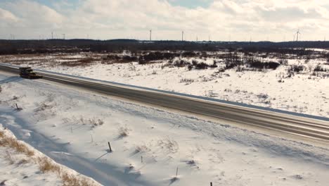 Truck-with-snowplough-clearing-freeway-from-snow-in-America