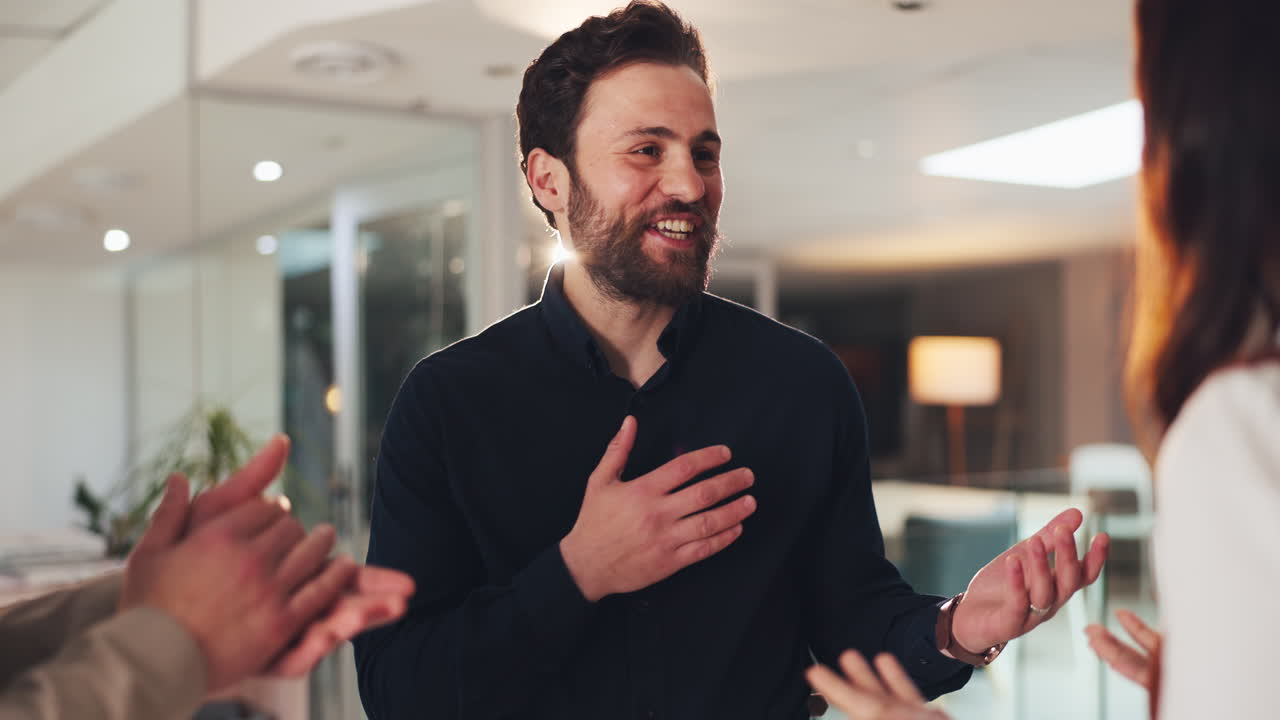 Man receiving applause for his achievements in a business setting