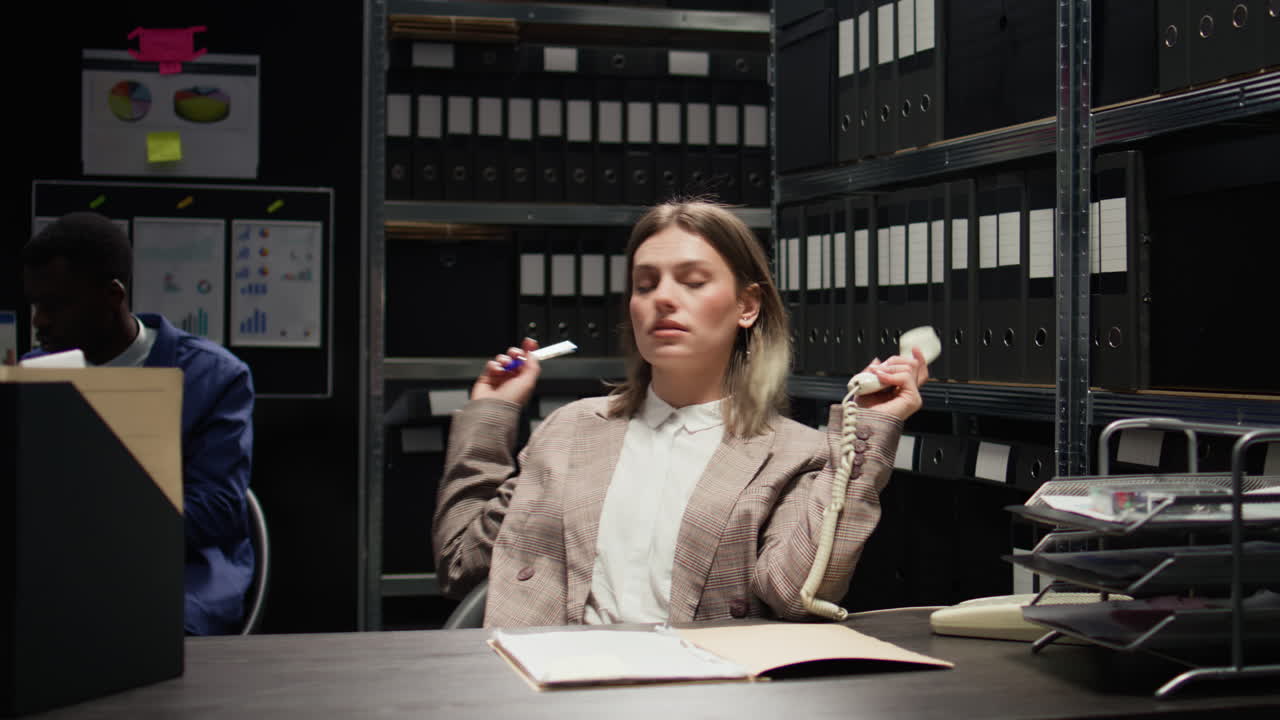 Woman in Office with Phone and Paperwork