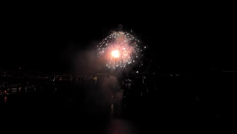 Beautiful-fireworks-in-Bergen-Norway-during-new-year-celebration---Aerial-showing-fireworks-in-byfjorden-launched-from-a-boat