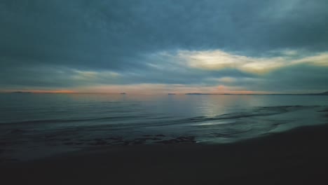 Aerial-view-over-the-beach-at-the-evening-with-dramatic-sky