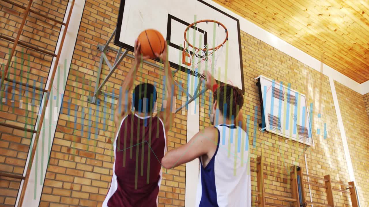 Maroon player shifting feet and cradling ball in school gym, initiating low-post drive toward rim