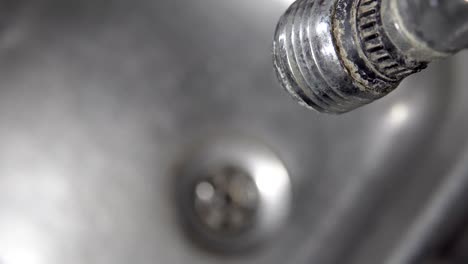 tap, sink, drain and dripping water, cinematic background loop