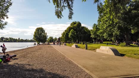 people enjoying a sunny summer day in city park, motion time lapse