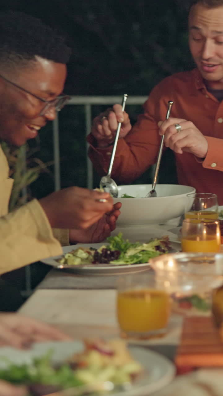 Happy Men Enjoying an Outdoor Dinner Party at Night