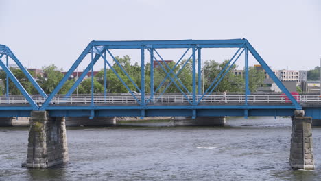 pedestrian running across a bridge with traffic in the background