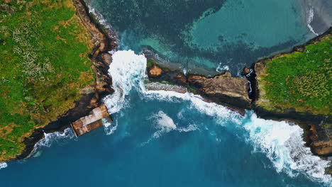 green cape blue lagoon coastline drone view. aerial water washing rocky cliff