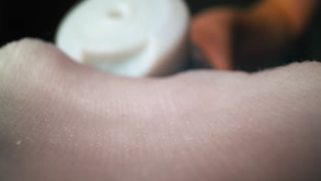 woman pours transparent liquid onto soft white rug in room