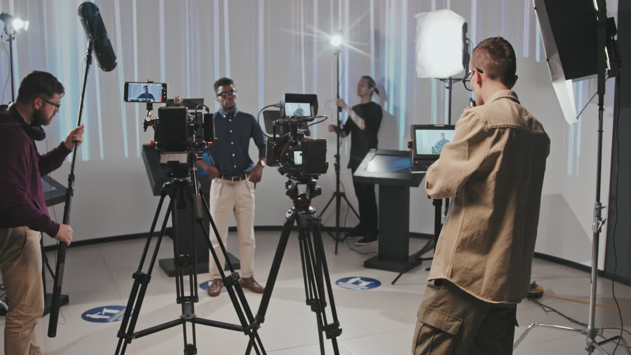 Male Filmmaking Crew Organizing Shooting Process