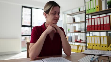 professional woman pondering at office desk