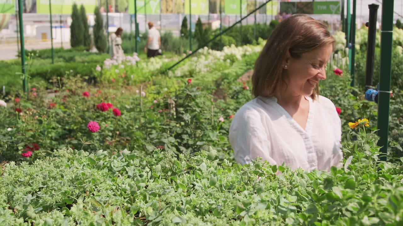 People with plants in a garden center