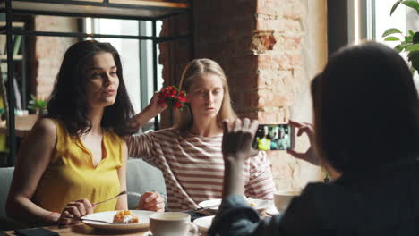 friends taking a picture in a cafe