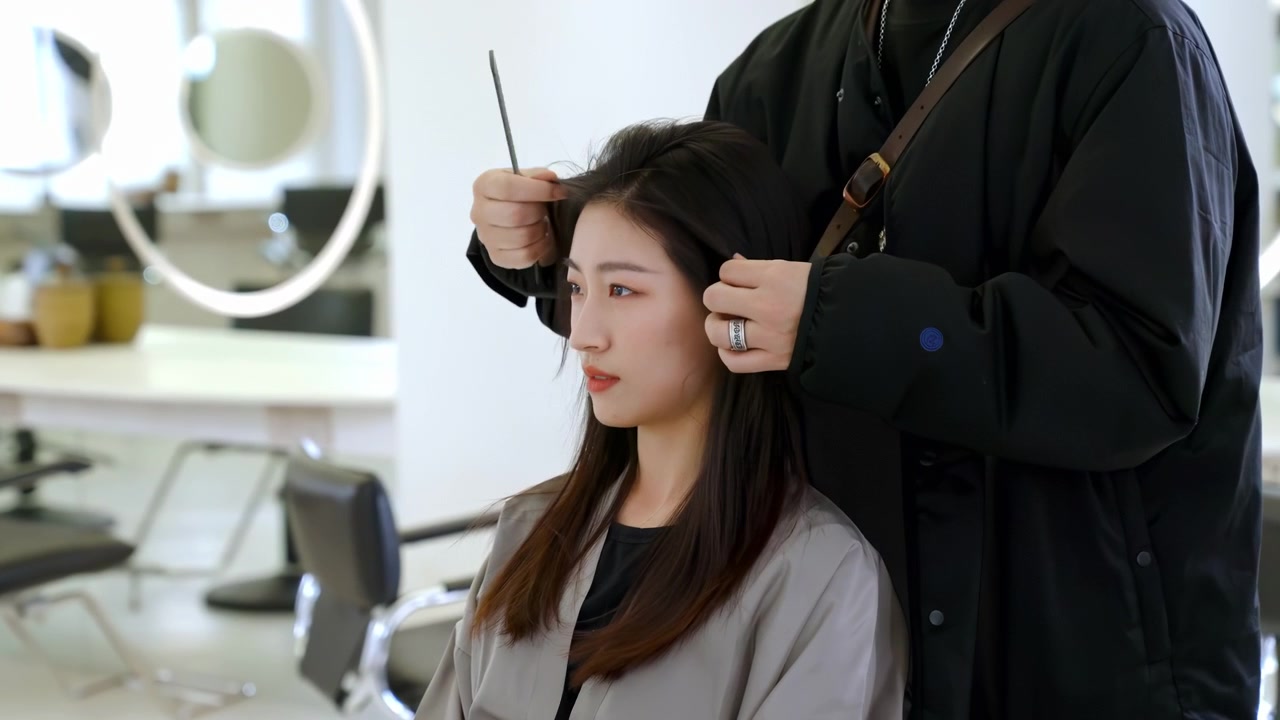 Master hairstylist stylist chatting consults with customer for service before hair appointment, hairdresser giving haircut grooming comb hairstyle to woman client at beauty salon barber shop business