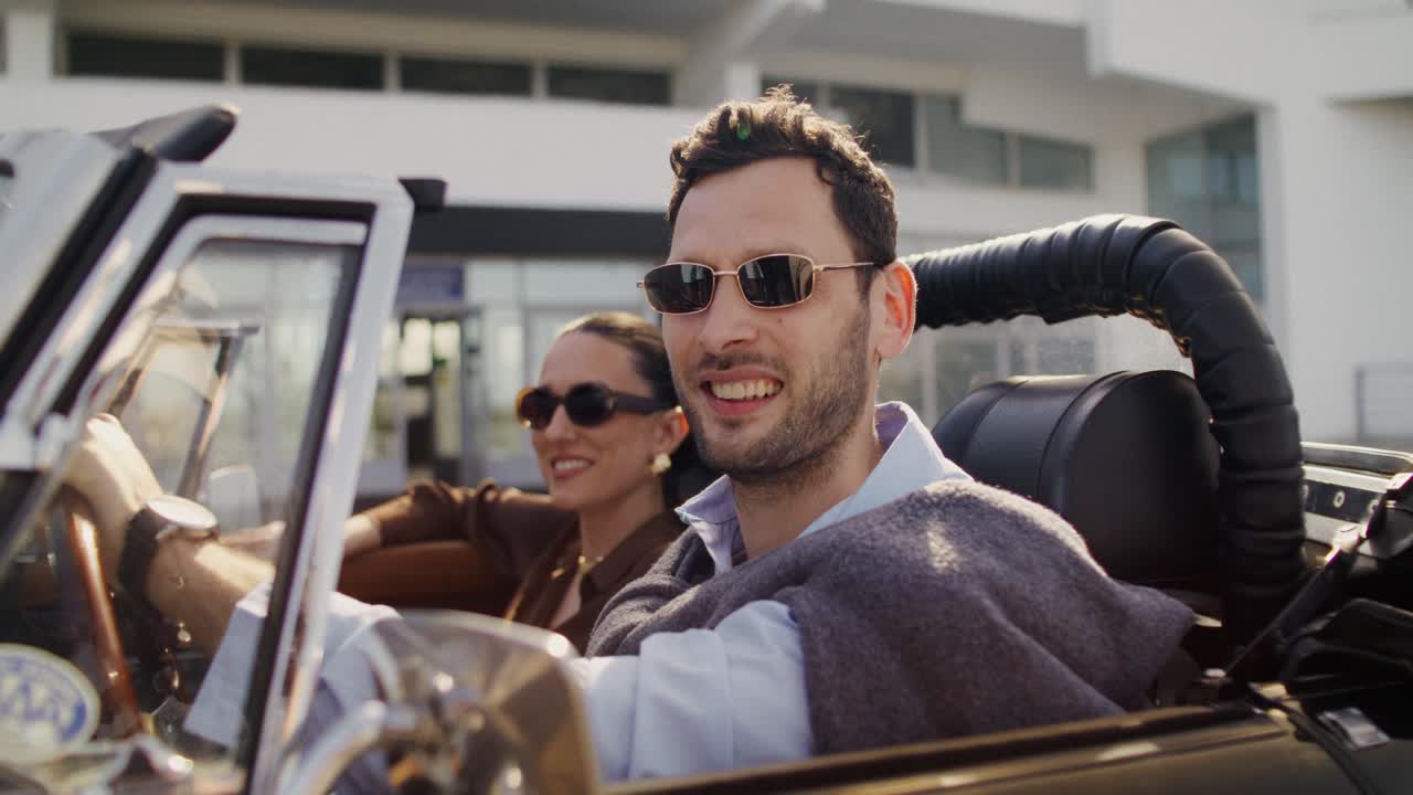 Couple Enjoying a Drive in a Convertible Car