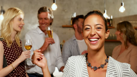 Woman-smiling-while-friends-having-drinks-in-the-bar-4K-4k