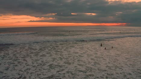 surfers enjoying a sunset at the beach
