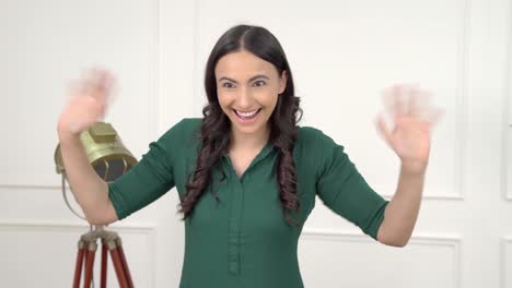 Indian-girl-waving-Hello-with-both-hands