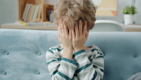 unhappy child on a couch