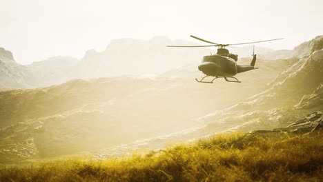 slow motion vietnam war era helicopter in mountains