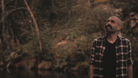 man by river enjoys golden scenery and sunlight rim light around him. he feels serene and tranquil. soothing and warm nature clip