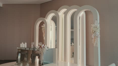 illuminated arched mirrors with soft floral accents in a refined pastel-toned interior space