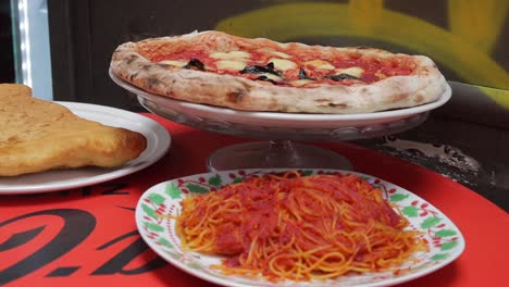 display of traditional cooked italian authentic cuisine spaghetti and pizza