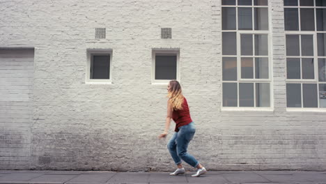 contemporary funky caucasian woman street dancer dancing freestyle in the city